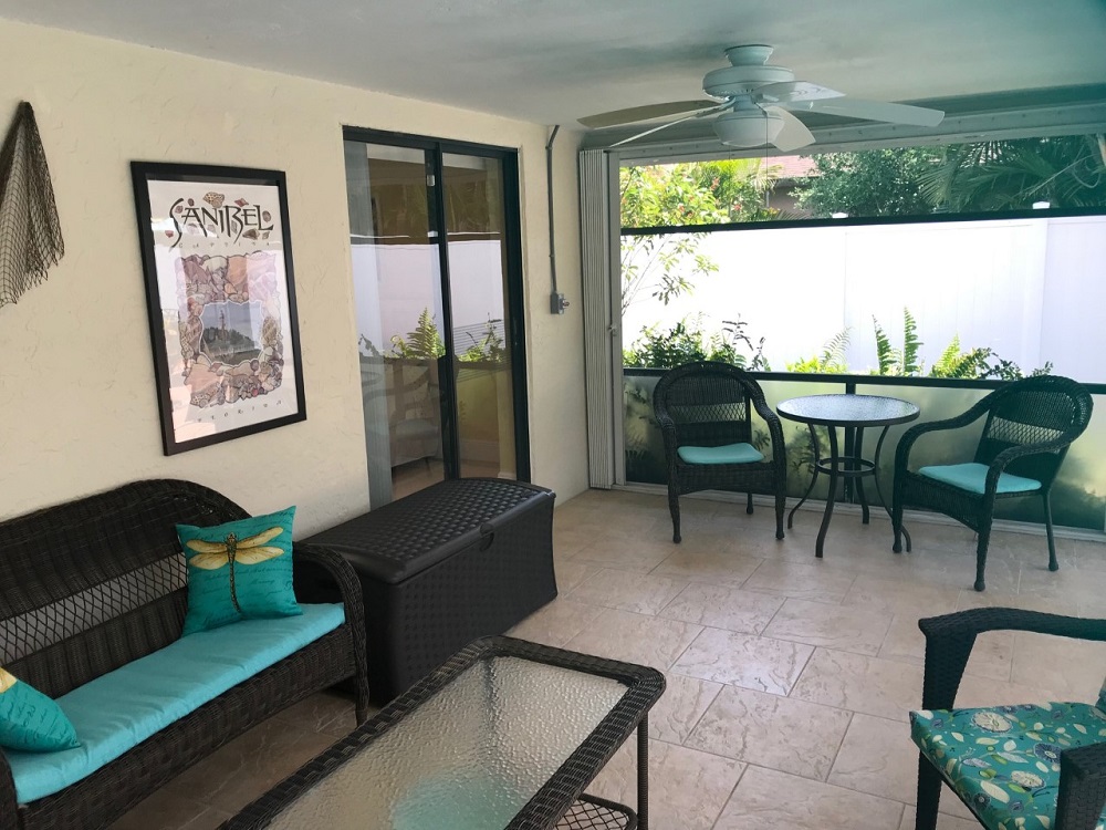 Two Ceiling Fans Keep The Tropical Breezes Circulating In This Generous Sized Lanai
